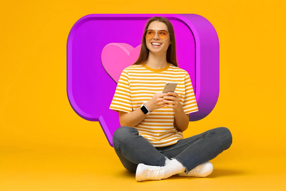 Smiling creator holding a phone in front of a giant like icon